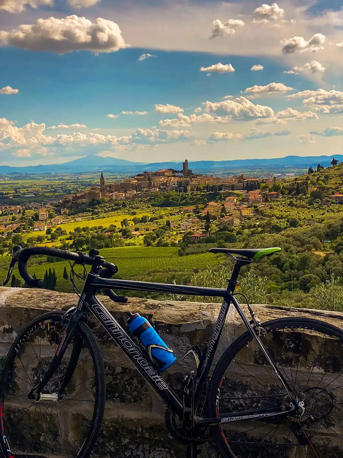 bike leaning against a stone wall overlooking a scenic valley