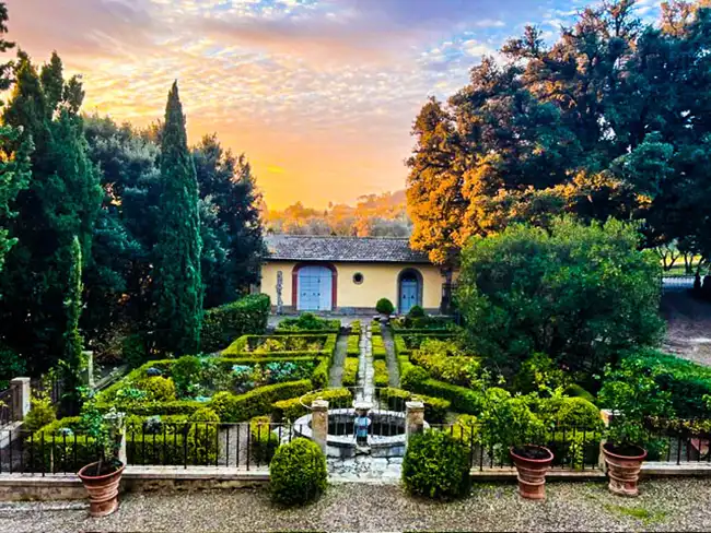 view of a garden with a fountain and a house